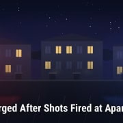 Fostoria News Night scene of apartments with lit windows after shooting incident.